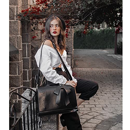 Woman sitting on a stone bench with a black handbag. 